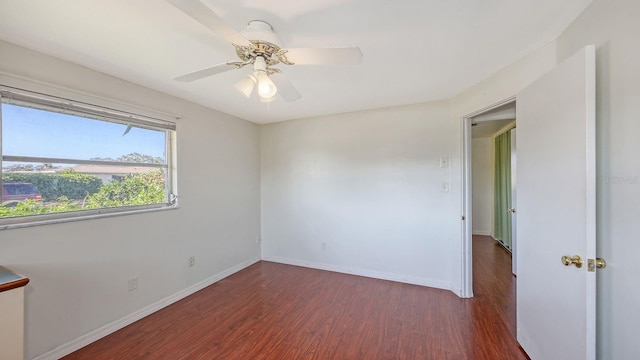 empty room with dark hardwood / wood-style flooring and ceiling fan