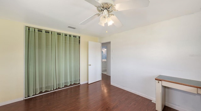 empty room with ceiling fan and dark hardwood / wood-style floors