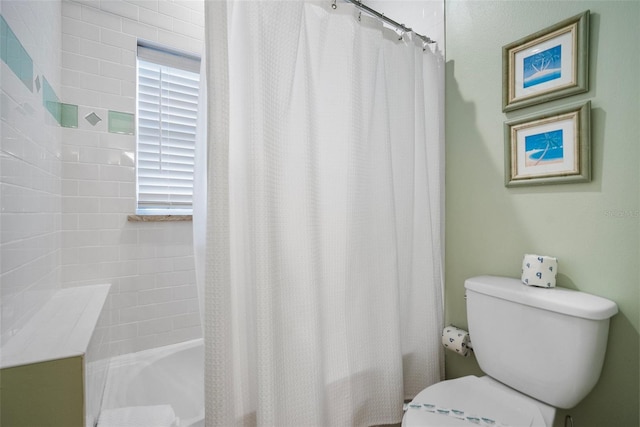 bathroom with toilet and shower / bath combo