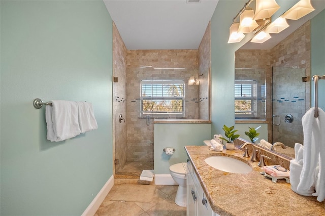 bathroom with toilet, a shower with shower door, vanity, and tile patterned flooring