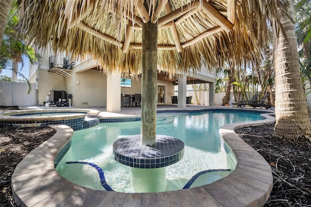 view of swimming pool featuring an in ground hot tub and a gazebo