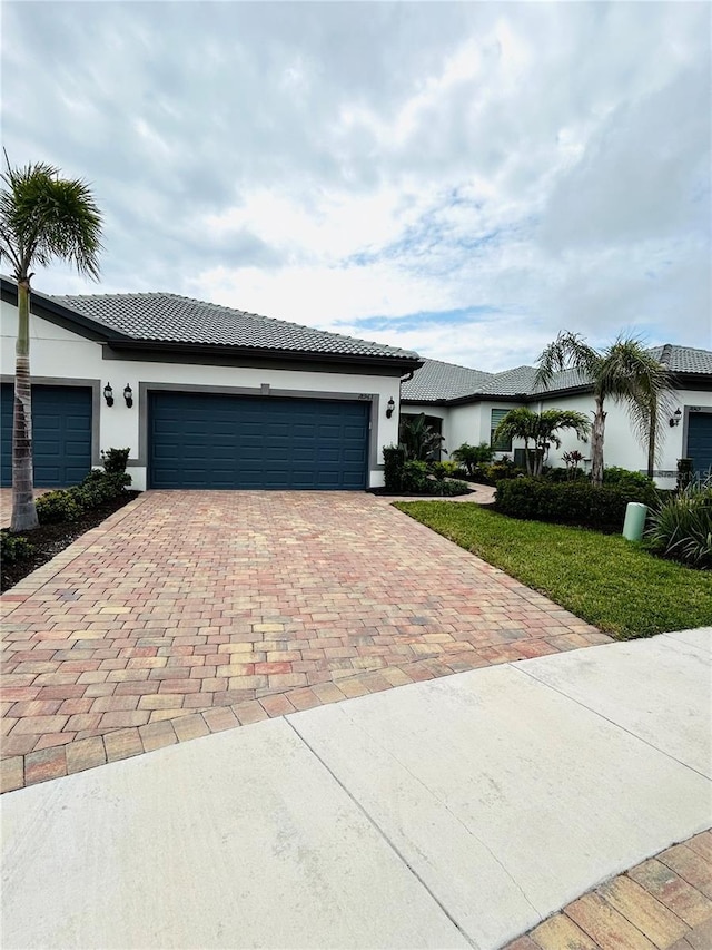 view of front of property with a front lawn and a garage