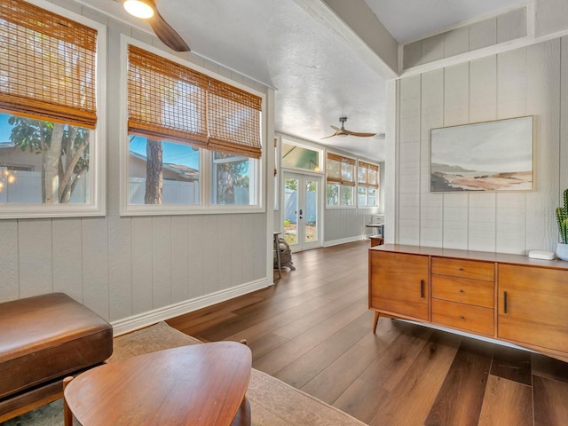 sitting room with dark wood-style floors, french doors, baseboards, and a ceiling fan