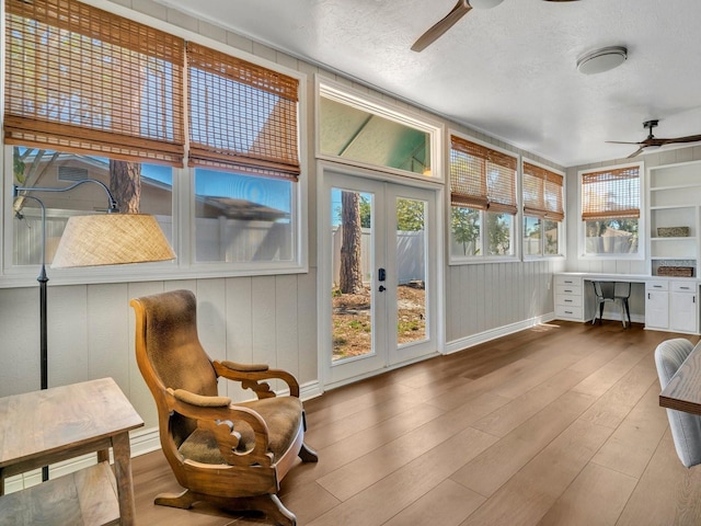 sunroom / solarium with ceiling fan and built in study area