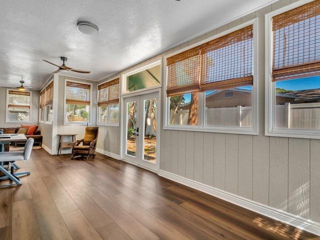 sunroom featuring a ceiling fan