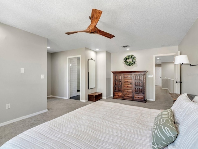 bedroom with baseboards, visible vents, a textured ceiling, and light colored carpet