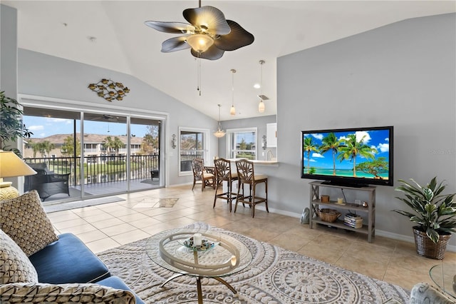 tiled living room with ceiling fan and high vaulted ceiling