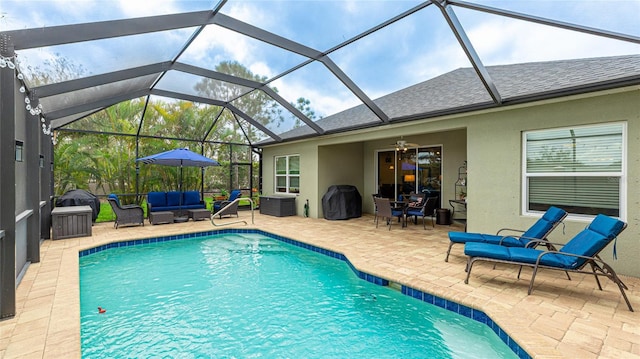 pool featuring glass enclosure, an outdoor living space, a ceiling fan, and a patio