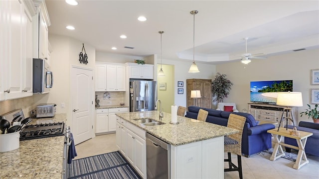 3839 Autumn Fern Ter, Sarasota, FL 34243 - kitchen with appliances with stainless steel finishes, open floor plan, tasteful backsplash, a sink, and recessed lighting