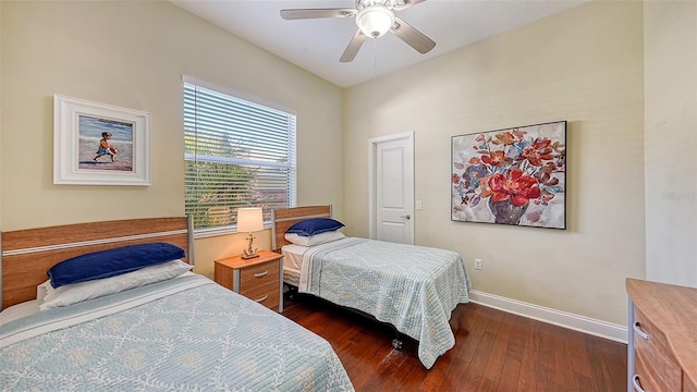 bedroom featuring dark wood-style floors, baseboards, and ceiling fan