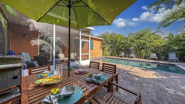 outdoor pool with a patio and outdoor dining area