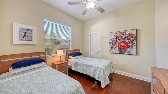 bedroom featuring ceiling fan, baseboards, and dark wood-style floors