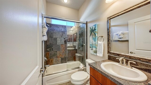 full bath featuring toilet, vanity, and shower / bath combination with glass door