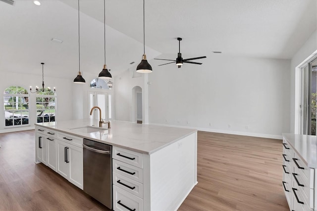 kitchen featuring sink, a kitchen island with sink, light stone countertops, white cabinets, and stainless steel dishwasher