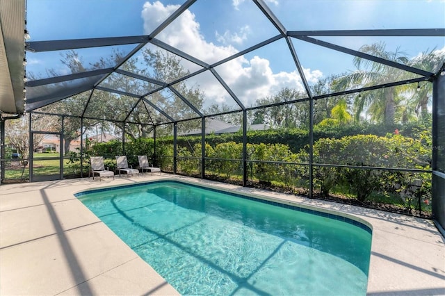 view of pool featuring a patio and glass enclosure