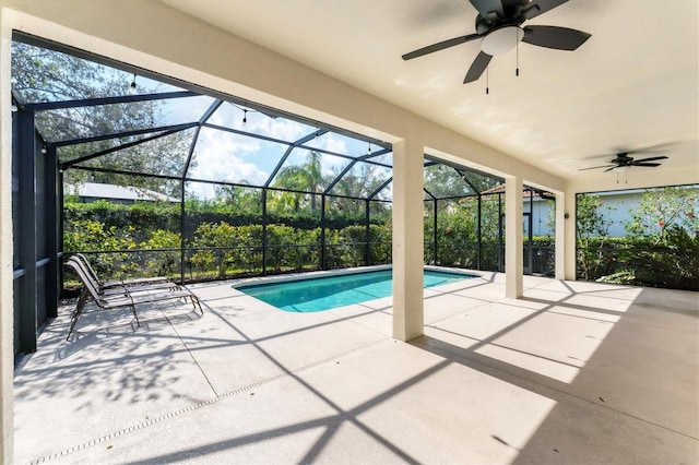 view of swimming pool featuring a patio, a lanai, and ceiling fan