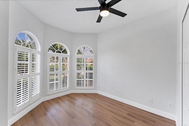 spare room with ceiling fan and light wood-type flooring