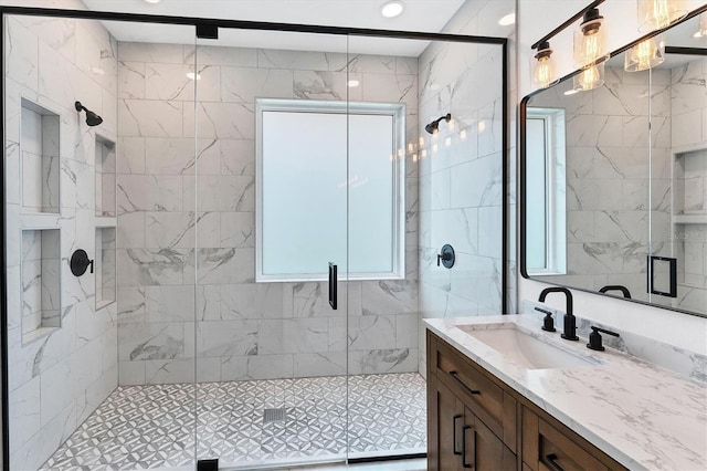 bathroom with vanity and a shower with shower door