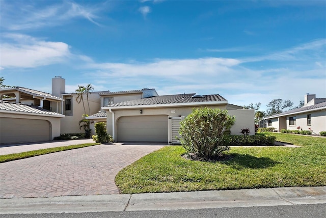 view of front of home featuring a front lawn and a garage