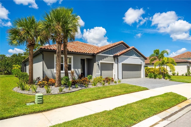 view of front of home with an attached garage, a tile roof, decorative driveway, stucco siding, and a front yard