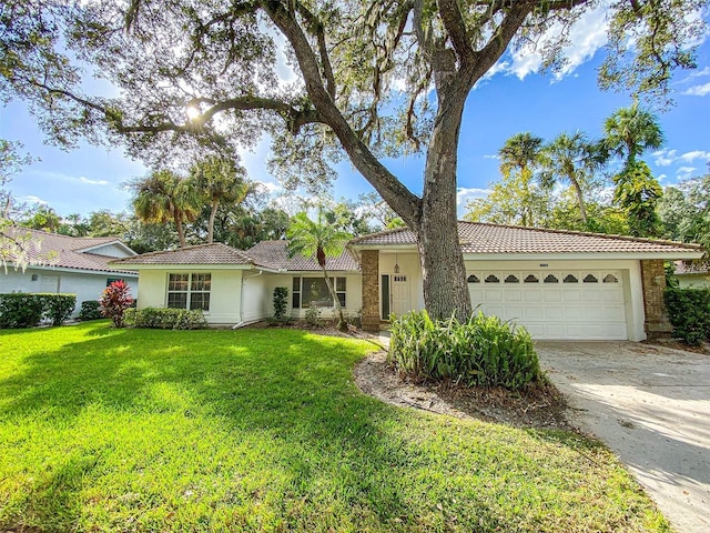 ranch-style house featuring a garage and a front lawn