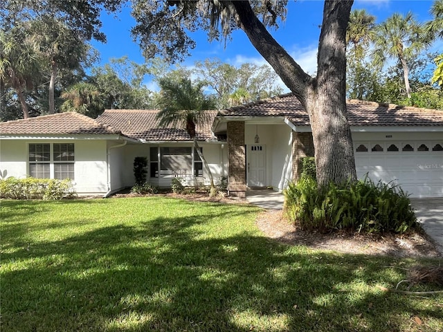 ranch-style house featuring a garage and a front lawn