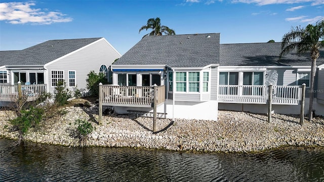 rear view of property with a water view