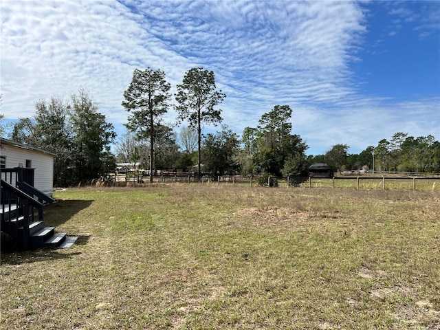 view of yard with a rural view