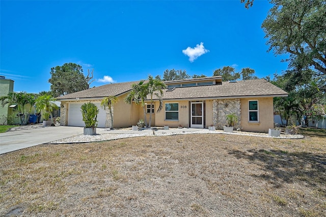 ranch-style house featuring a front lawn and a garage