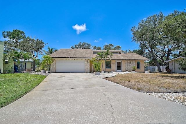 single story home featuring a front lawn and a garage