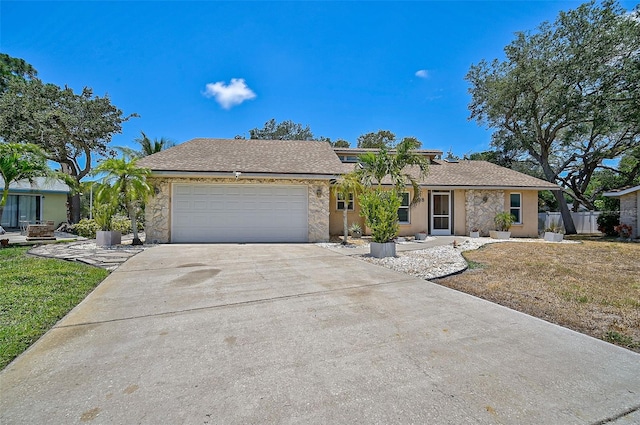 ranch-style house featuring a front lawn and a garage