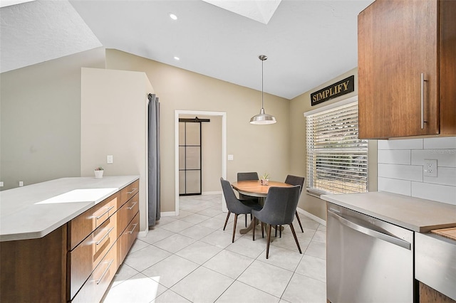 kitchen featuring stainless steel dishwasher, vaulted ceiling, light tile patterned flooring, decorative backsplash, and pendant lighting