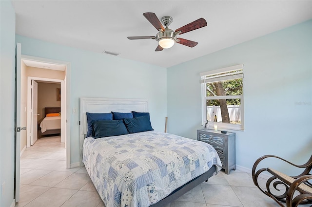 tiled bedroom with ceiling fan