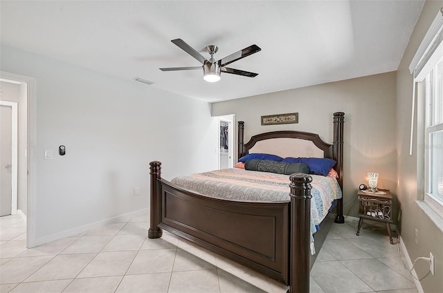 tiled bedroom featuring ceiling fan