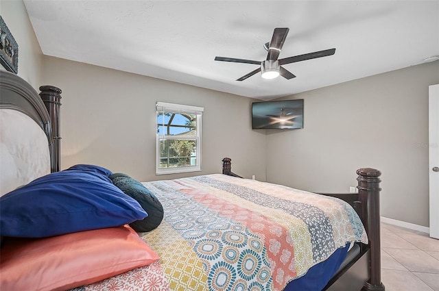 tiled bedroom featuring ceiling fan