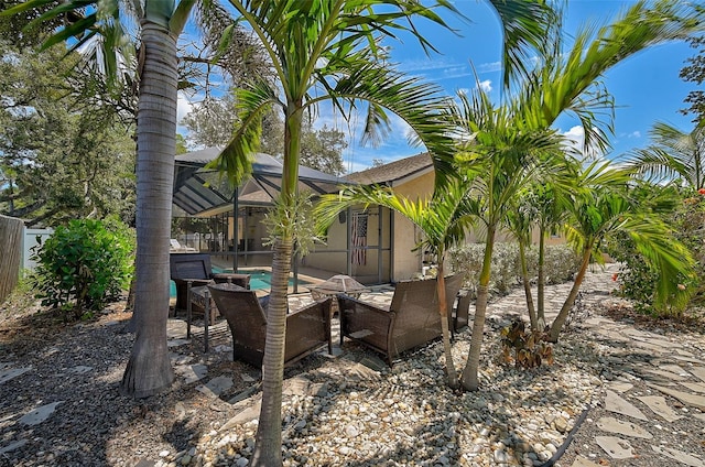 view of yard featuring a patio and glass enclosure