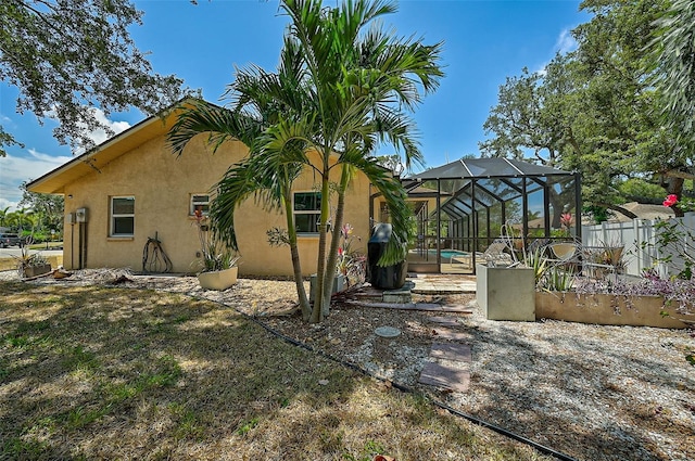 view of side of property with a lanai