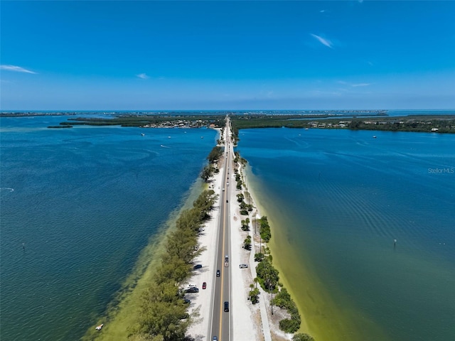 drone / aerial view featuring a water view and a view of the beach