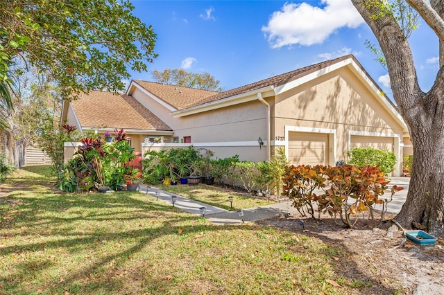 view of front of house with a garage and a front yard