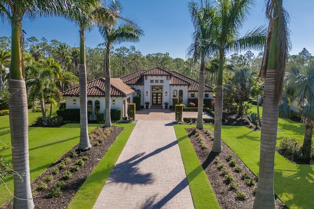 19424 Ganton Ave, Lakewood Ranch, FL 34202 - mediterranean / spanish-style home featuring french doors, stucco siding, a tiled roof, and a front yard
