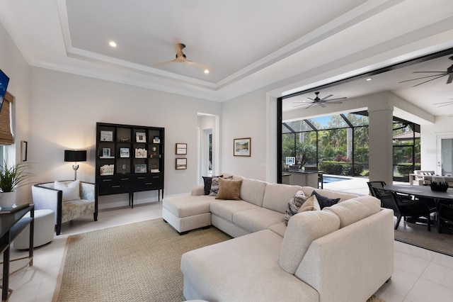 19424 Ganton Ave, Lakewood Ranch, FL 34202 - living room with ceiling fan, a healthy amount of sunlight, and a tray ceiling