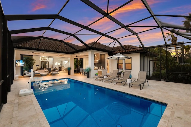 19424 Ganton Ave, Lakewood Ranch, FL 34202 - back of property at dusk with ceiling fan, a tile roof, an outdoor pool, a patio area, and outdoor lounge area