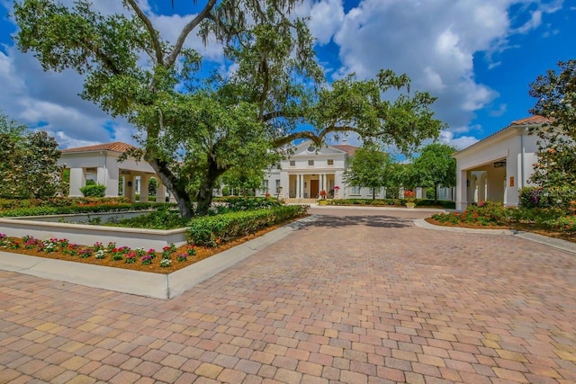 19424 Ganton Ave, Lakewood Ranch, FL 34202 - mediterranean / spanish house featuring a tiled roof, decorative driveway, and stucco siding