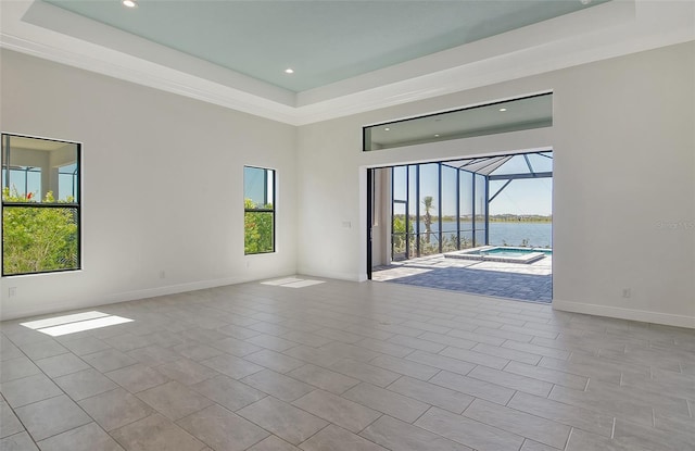 552 Bocelli Dr, North Venice, FL 34275 - empty room with baseboards, a water view, a tray ceiling, and a sunroom