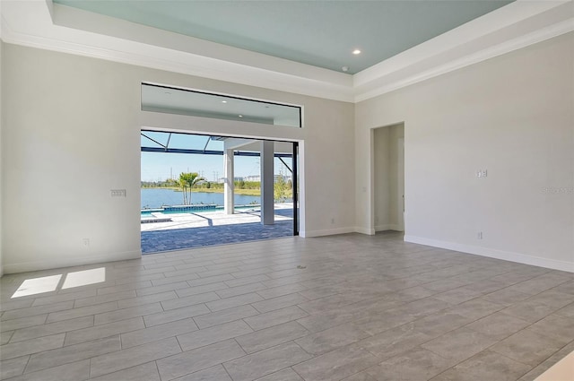 552 Bocelli Dr, North Venice, FL 34275 - unfurnished room with a towering ceiling, a raised ceiling, baseboards, and a water view