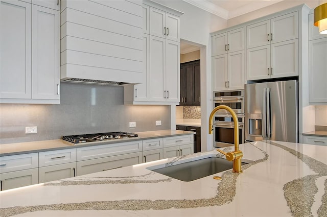 552 Bocelli Dr, North Venice, FL 34275 - kitchen with crown molding, light stone counters, decorative backsplash, appliances with stainless steel finishes, and a sink