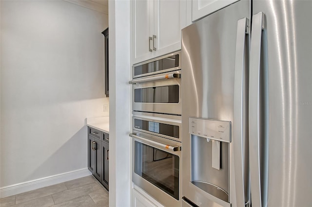 552 Bocelli Dr, North Venice, FL 34275 - kitchen featuring baseboards, white cabinetry, appliances with stainless steel finishes, and light countertops