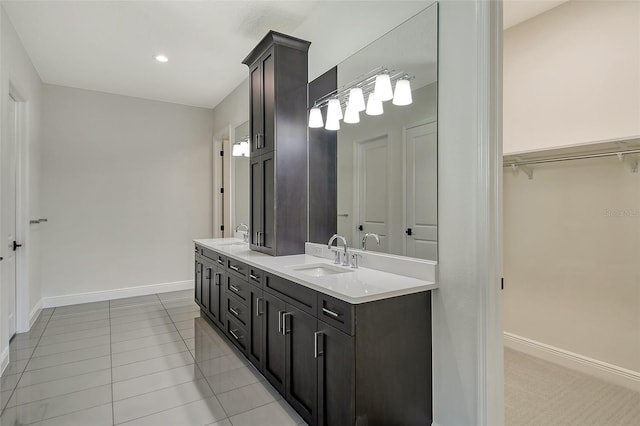 552 Bocelli Dr, North Venice, FL 34275 - bathroom with a sink, a walk in closet, baseboards, and double vanity