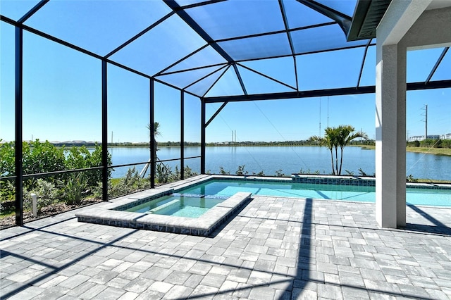 552 Bocelli Dr, North Venice, FL 34275 - view of pool with glass enclosure, a patio, a pool with connected hot tub, and a water view