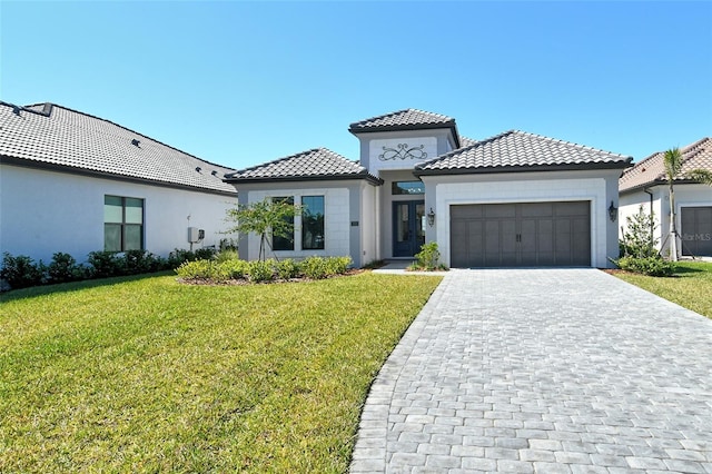 552 Bocelli Dr, North Venice, FL 34275 - mediterranean / spanish house with a front yard, stucco siding, a garage, a tile roof, and decorative driveway